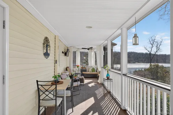 a balcony with furniture and a potted plant