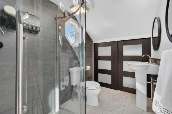 a bathroom with a toilet and a shower