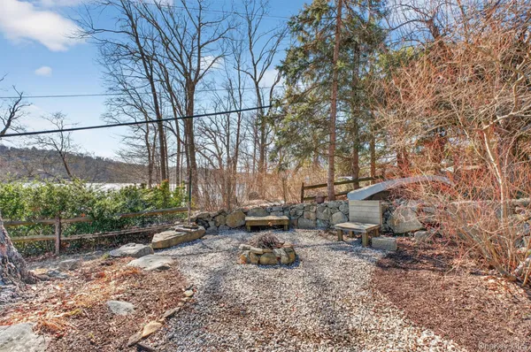 a backyard of a house with lots of green space and fountain