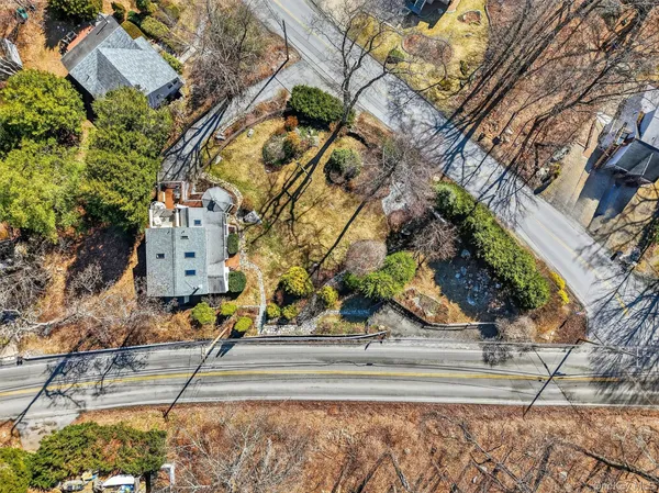 an aerial view of a house with a yard