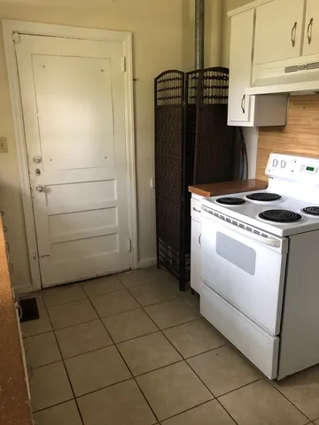 a kitchen with a stove and a refrigerator