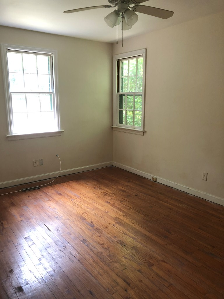 2834 Mimosa Street Columbus, GA 31906 - Photo 7 of 10 an empty room with wooden floor and windows