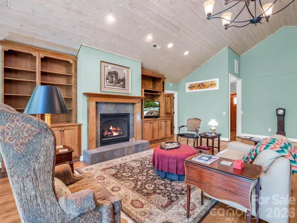 a room with a table chairs and a clock on the wall