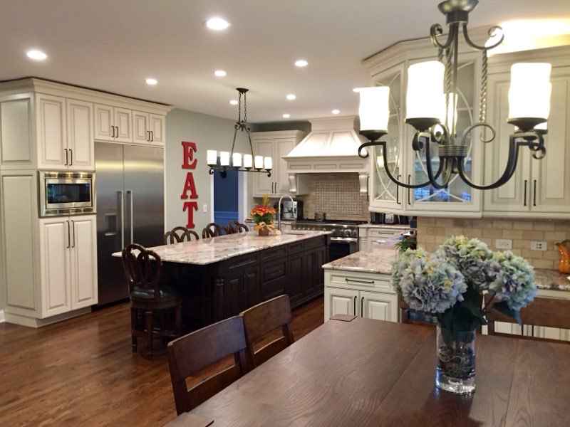 863 Bittersweet Drive Northbrook, IL 60062 - Photo 11 of 51 a kitchen with stainless steel appliances kitchen island granite countertop a table chairs in it and wooden floors