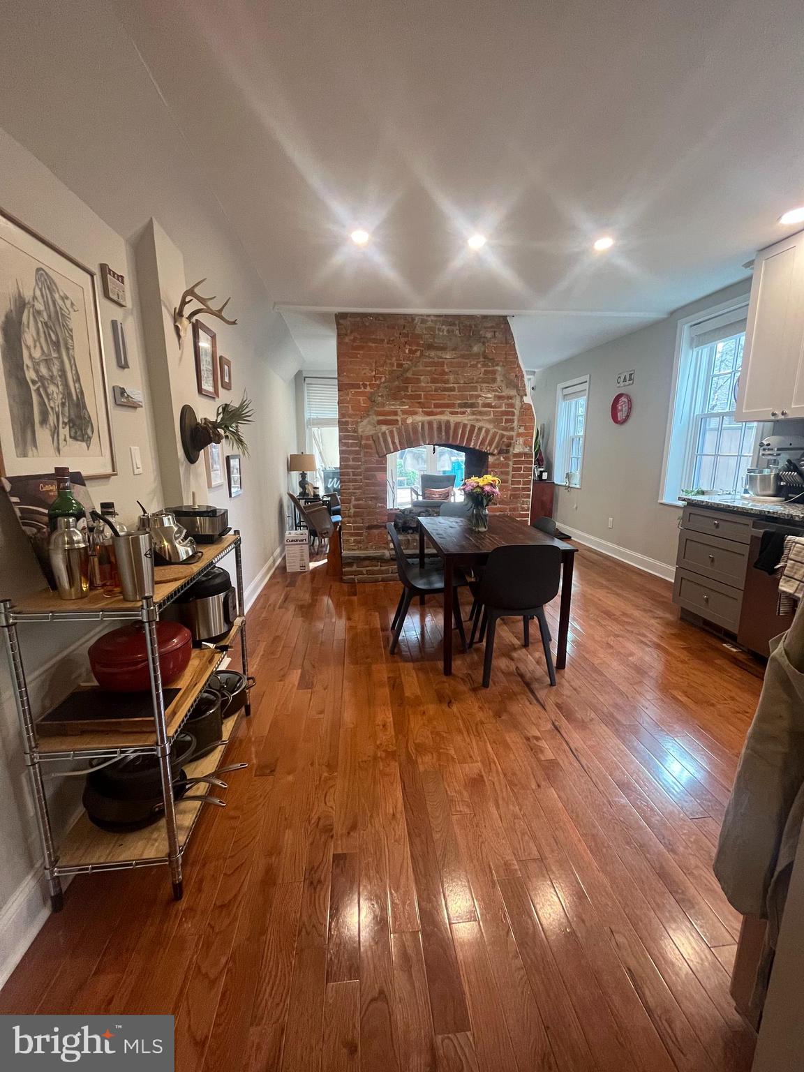 407 Cypress Street, Unit 1F Philadelphia, PA 19106 - Photo 3 of 14 a living room with furniture a dining table wooden floor and a large window