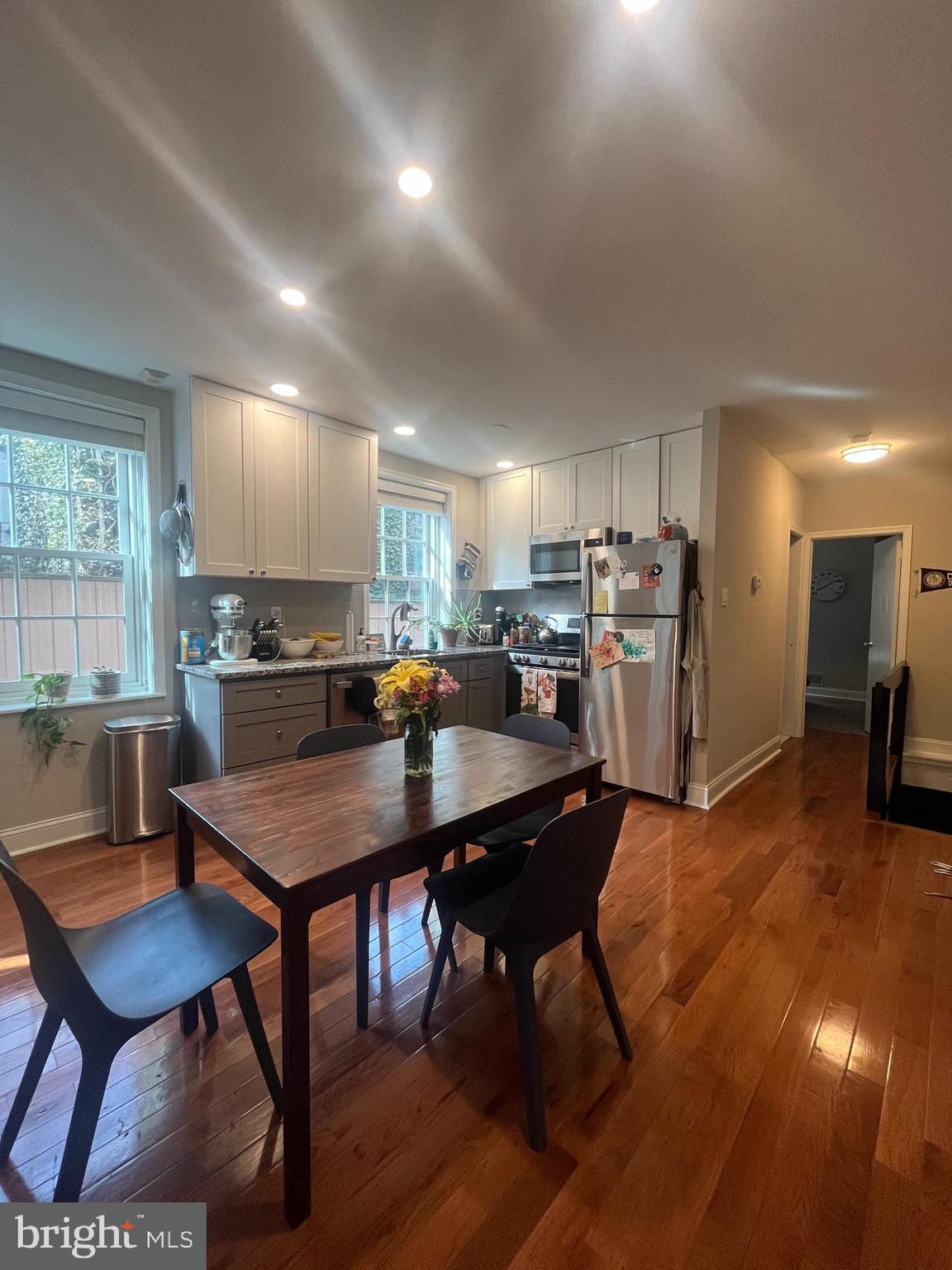 407 Cypress Street, Unit 1F Philadelphia, PA 19106 - Photo 6 of 14 a kitchen with a dining table chairs and refrigerator