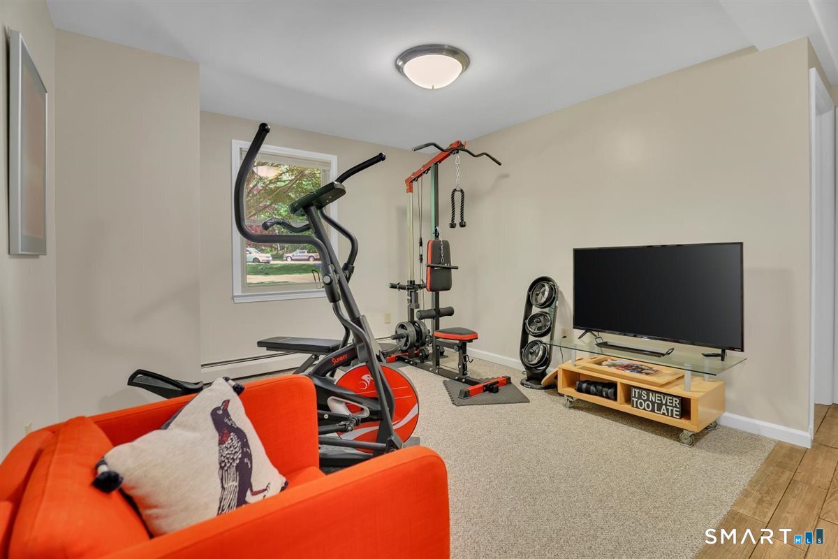 122 Ridgeview Circle Guilford, CT 06437 - Photo 25 of 40 Open flex space on the first level w/carpeting works well for an exercise area or den.