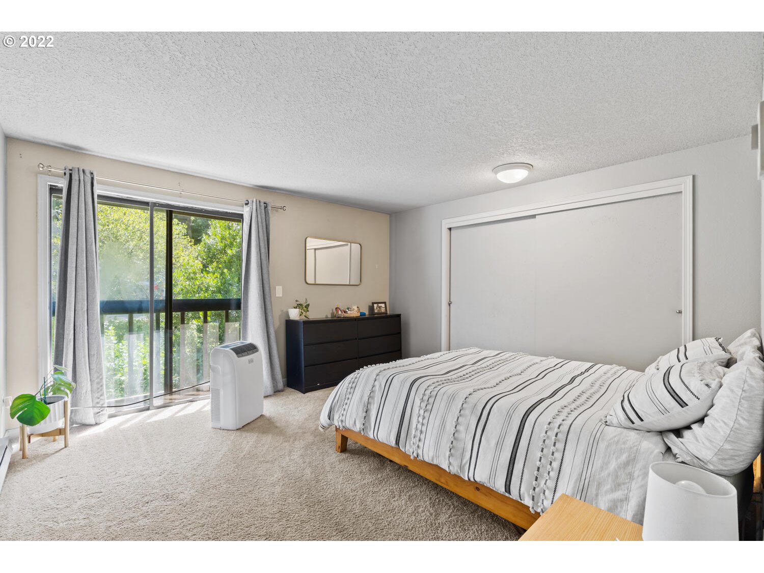5503 Southwest Multnomah Boulevard Portland, OR 97219 - Photo 11 of 21 a bedroom with a bed and wooden floor