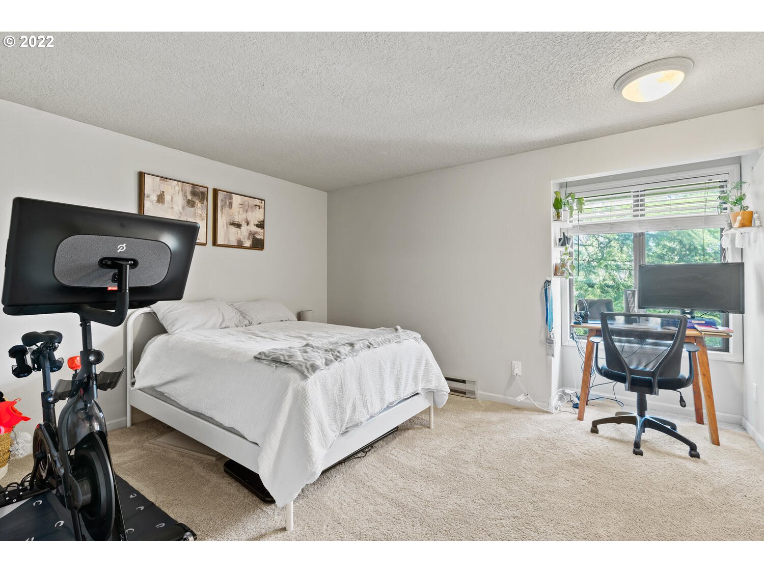 5503 Southwest Multnomah Boulevard Portland, OR 97219 - Photo 12 of 21 a bedroom with a bed and a table in it