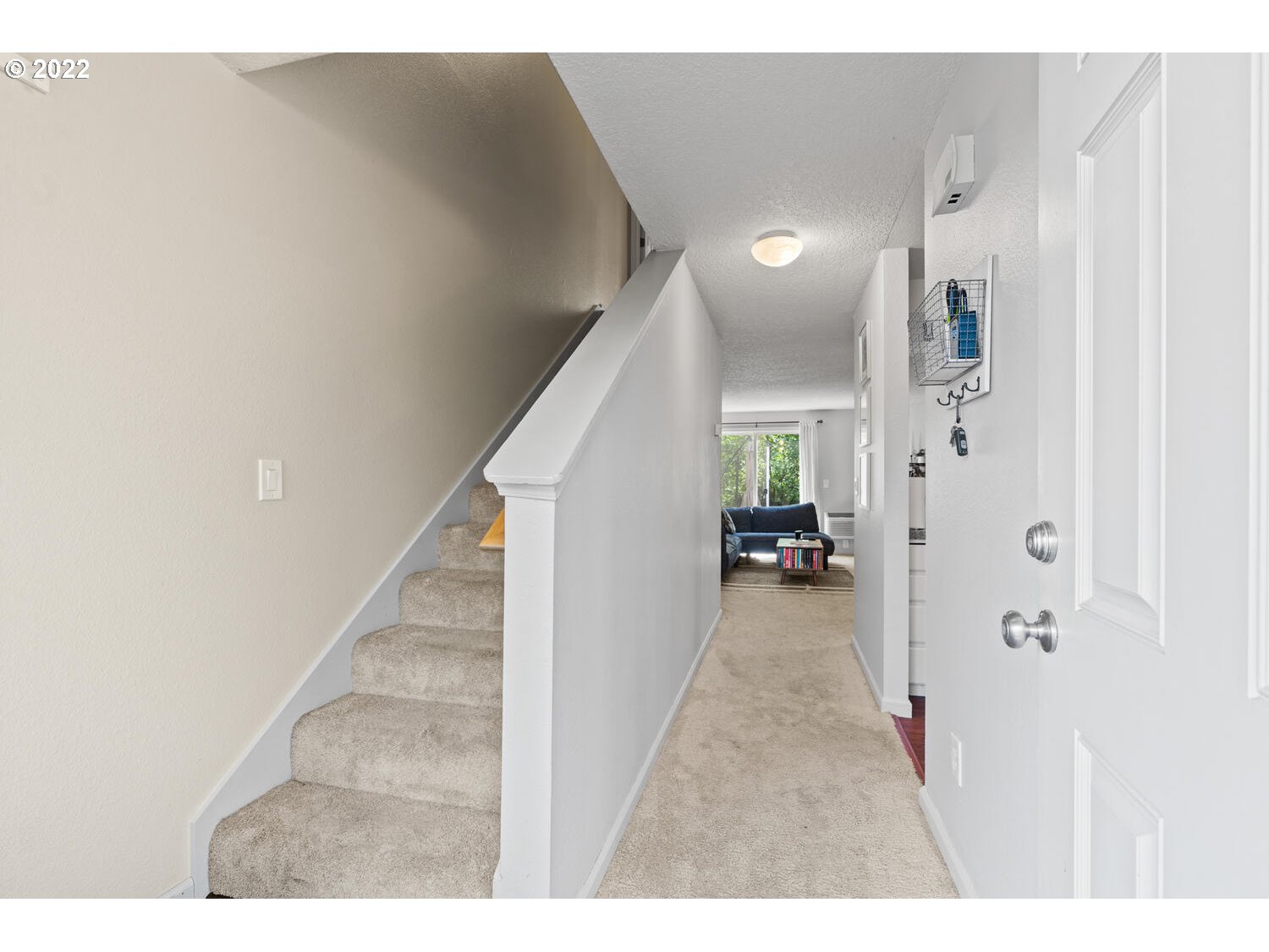 5503 Southwest Multnomah Boulevard Portland, OR 97219 - Photo 13 of 21 a view of a hallway with white walls and stairs