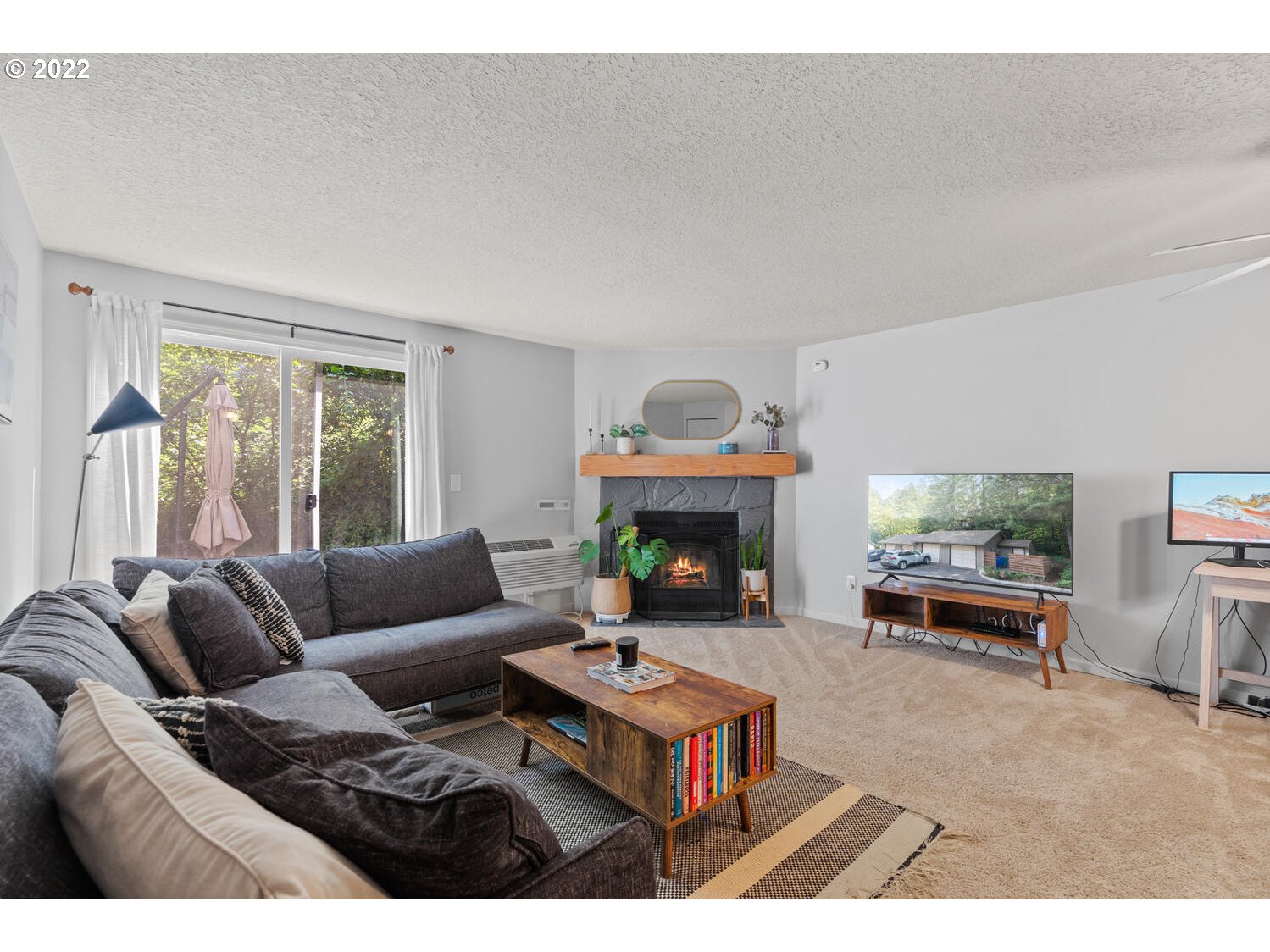 5503 Southwest Multnomah Boulevard Portland, OR 97219 - Photo 2 of 21 a living room with furniture a fireplace and a table