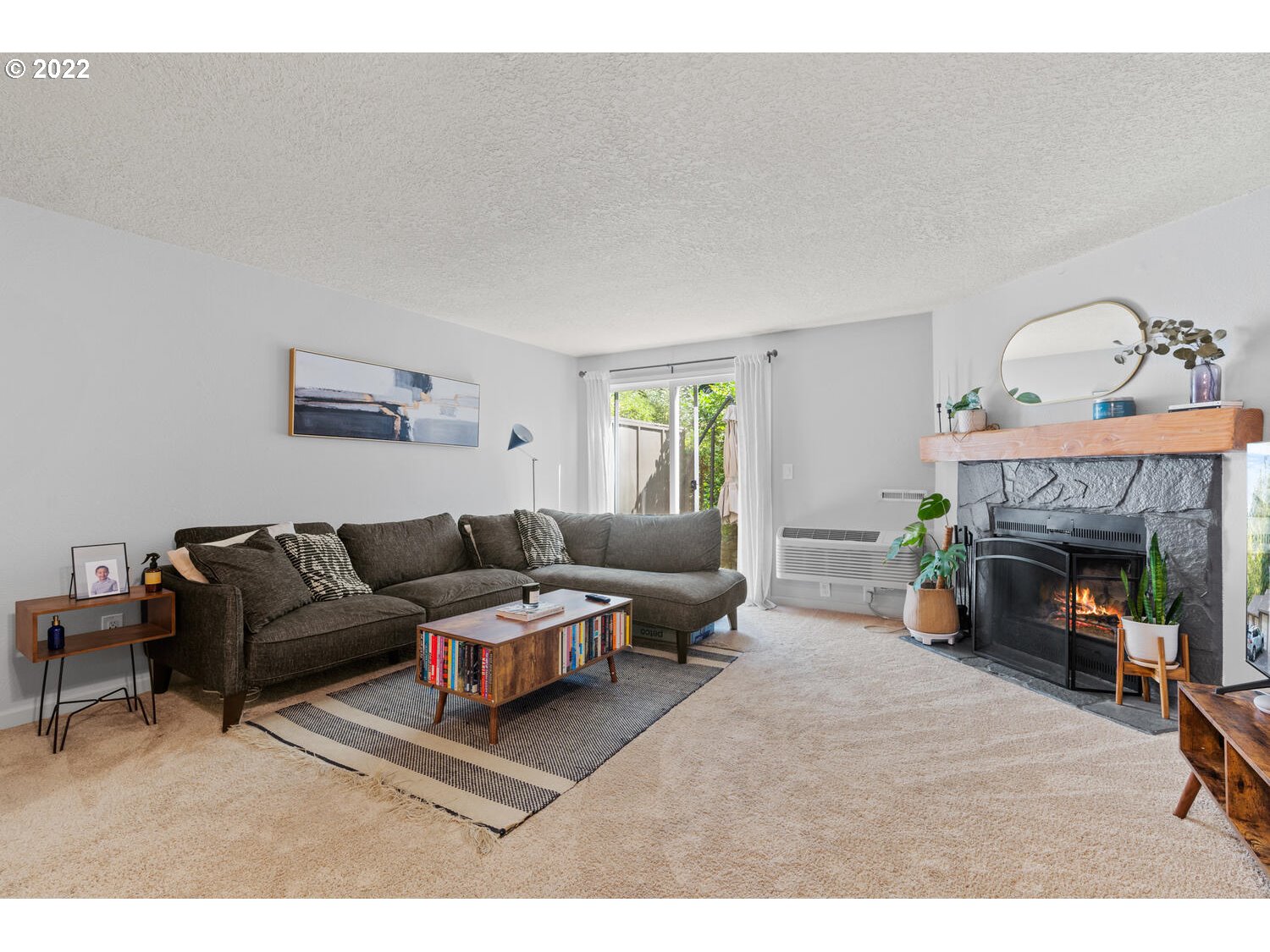 5503 Southwest Multnomah Boulevard Portland, OR 97219 - Photo 3 of 21 a living room with furniture and a fireplace