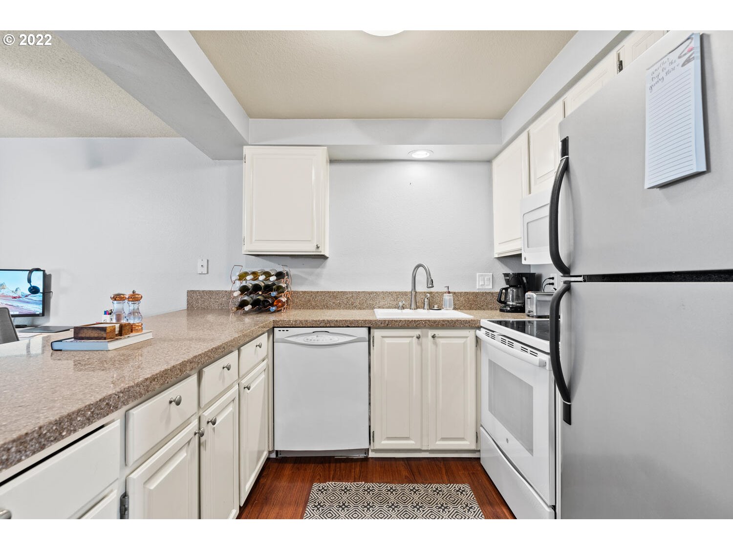 5503 Southwest Multnomah Boulevard Portland, OR 97219 - Photo 6 of 21 a kitchen with a sink stove and cabinets