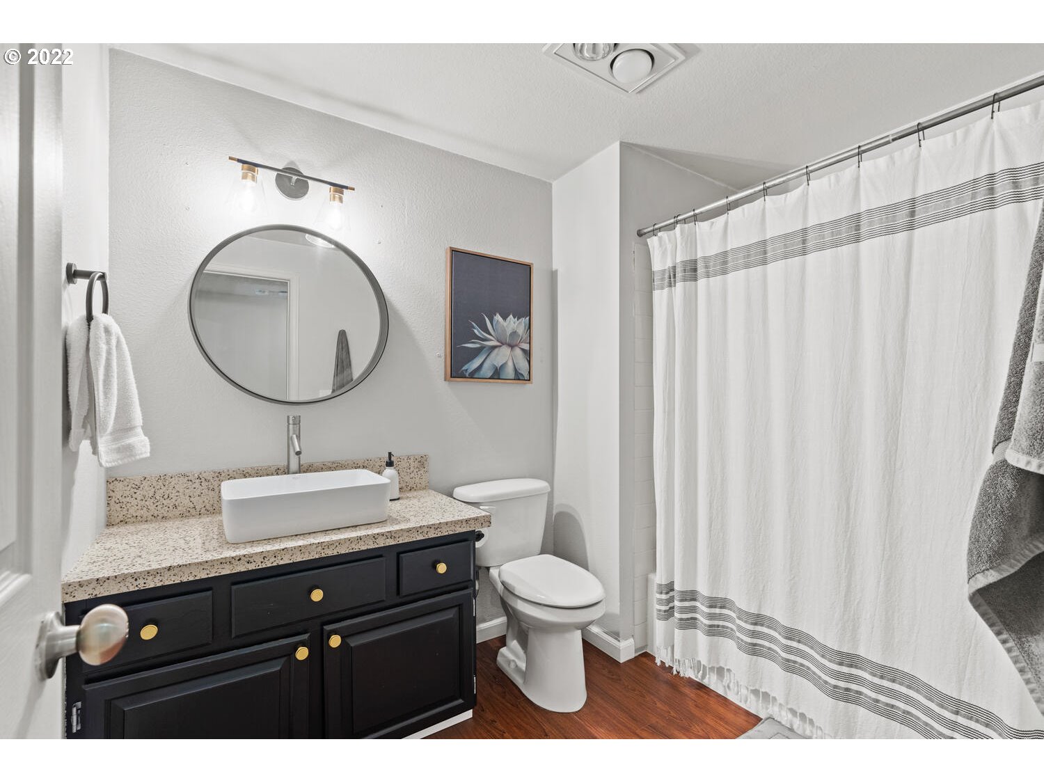 5503 Southwest Multnomah Boulevard Portland, OR 97219 - Photo 10 of 21 a bathroom with a sink vanity mirror and toilet