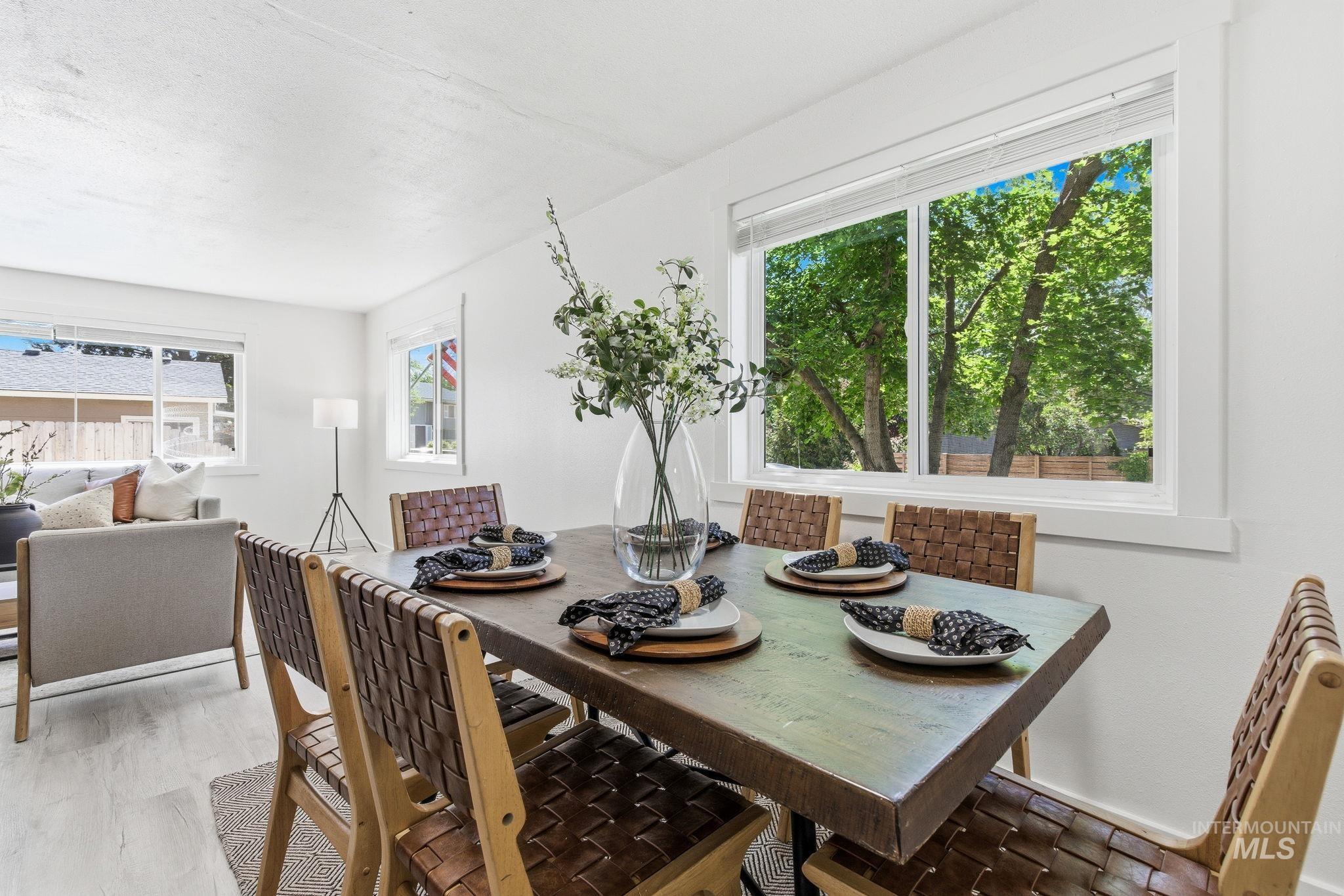 2224 Rachel Circle Boise, ID 83706 - Photo 22 of 50 Bright dining space featuring a large window with white trim, wood-finish flooring, and white painted walls