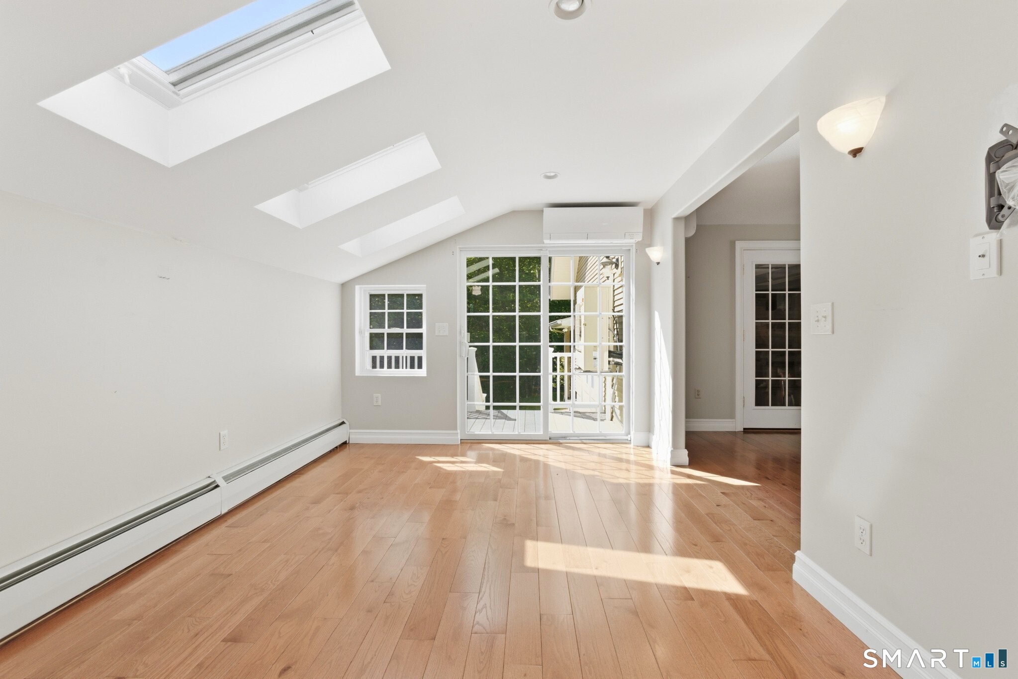 70 Mahoney Road Colchester, CT 06415 - Photo 5 of 40 a view of an empty room with a window and wooden floor