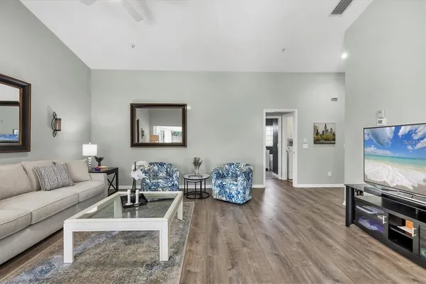 a living room with furniture and wooden floor