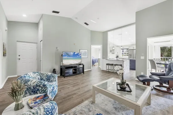 a living room with furniture a fireplace and large windows