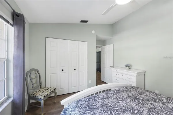 a bedroom with a bed and a chair in it