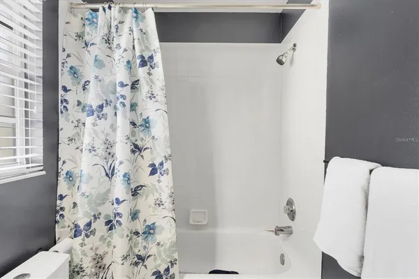 a bathroom with a bathtub and shower