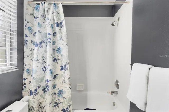 a bathroom with a bathtub and shower