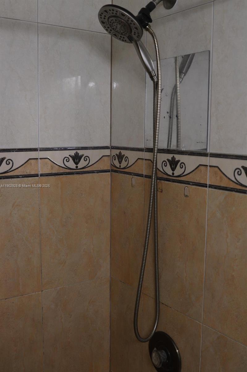 20022 Northwest 58th Court, Unit 1 Hialeah, FL 33015 - Photo 12 of 12 a bathroom with a shower