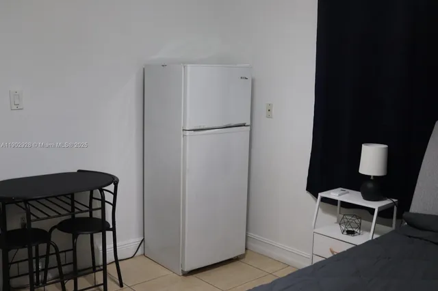 a white refrigerator freezer sitting in a kitchen