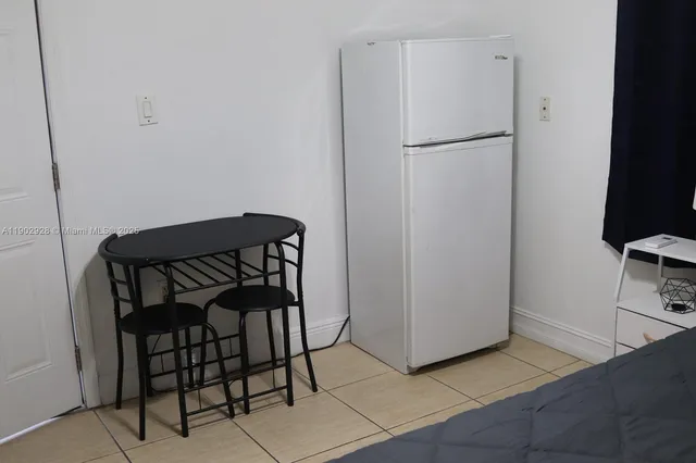 a kitchen with granite countertop white cabinets and a stove