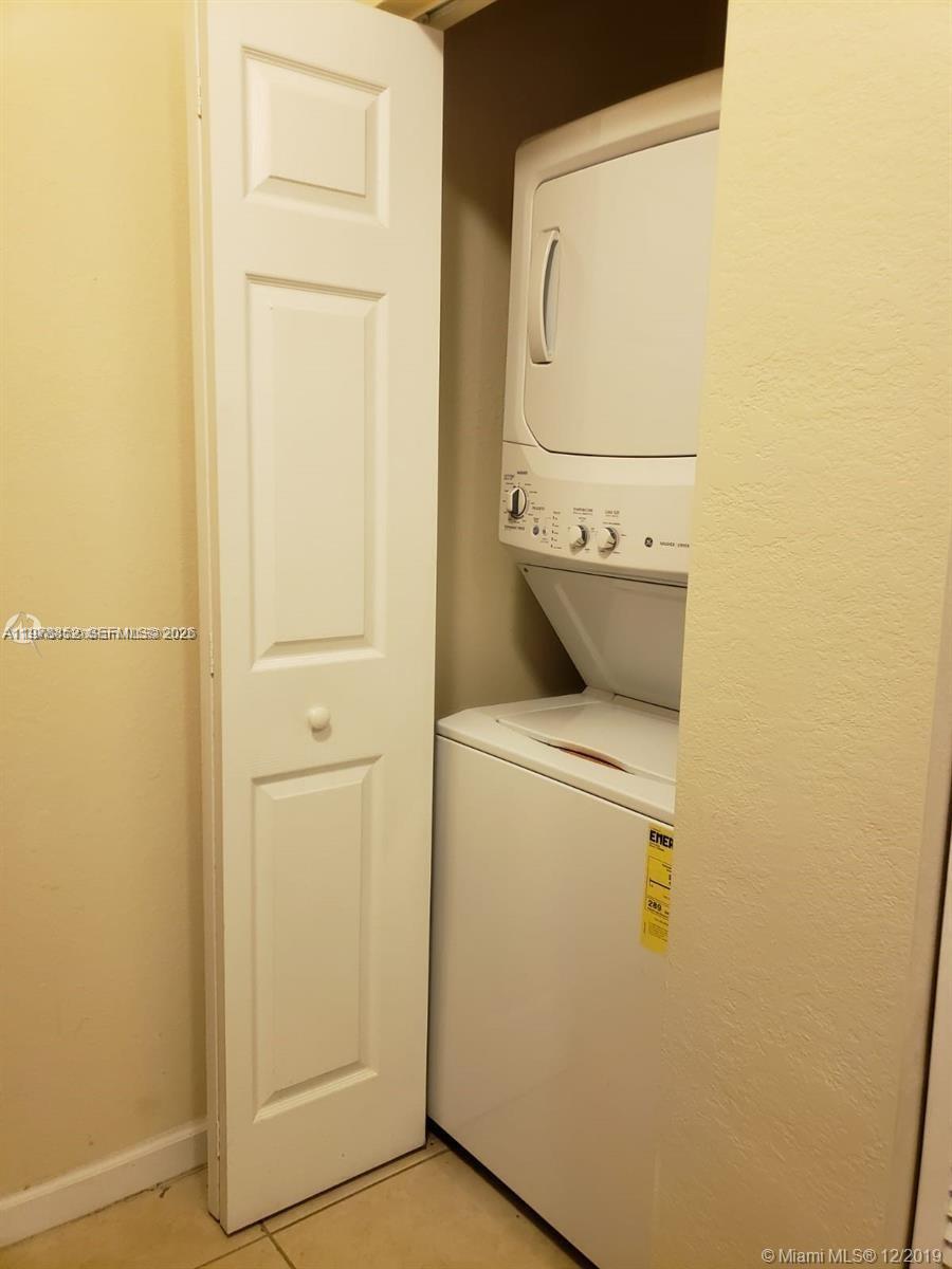 17120 Southwest 95th Terrace, Unit STUDIO Miami, FL 33196 - Photo 2 of 10 a utility room with dryer and washer