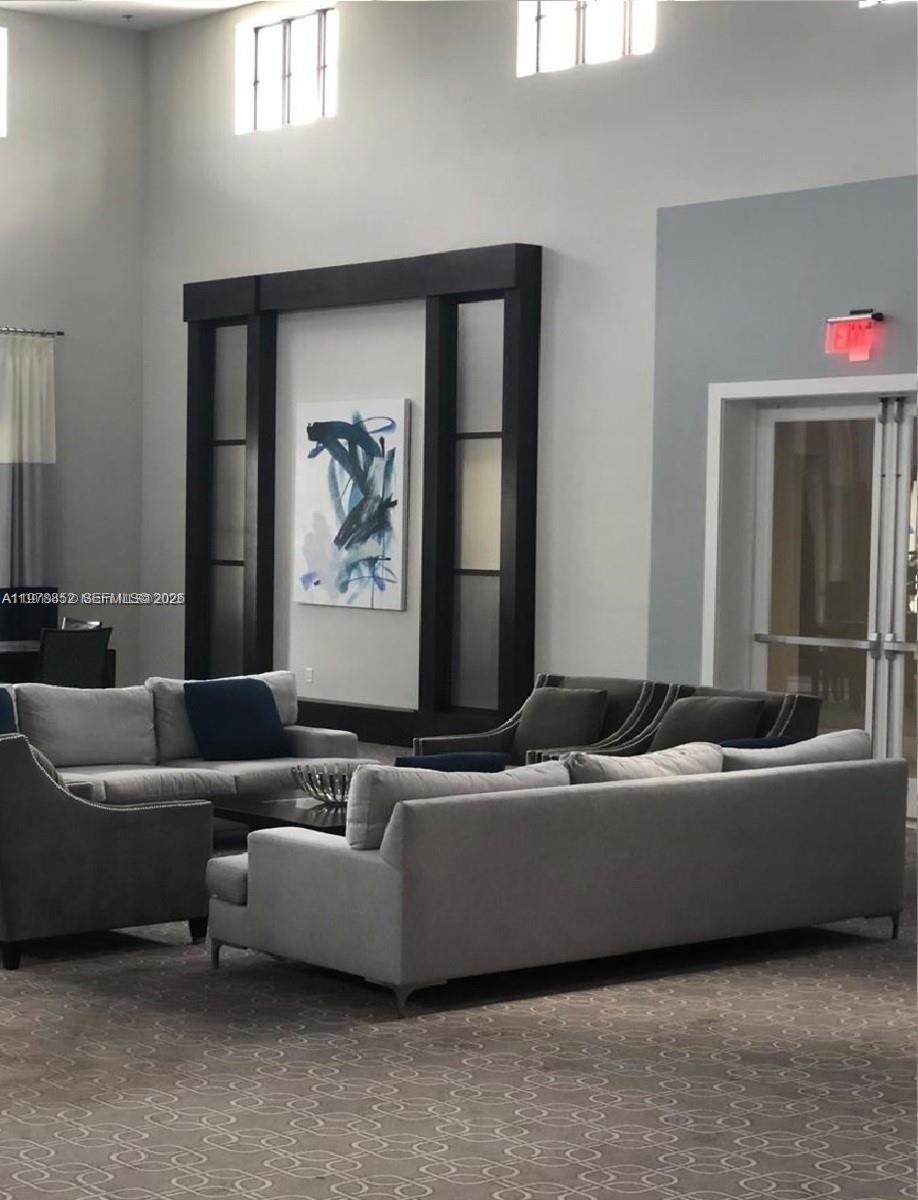 17120 Southwest 95th Terrace, Unit STUDIO Miami, FL 33196 - Photo 7 of 10 a living room with a couch and a window