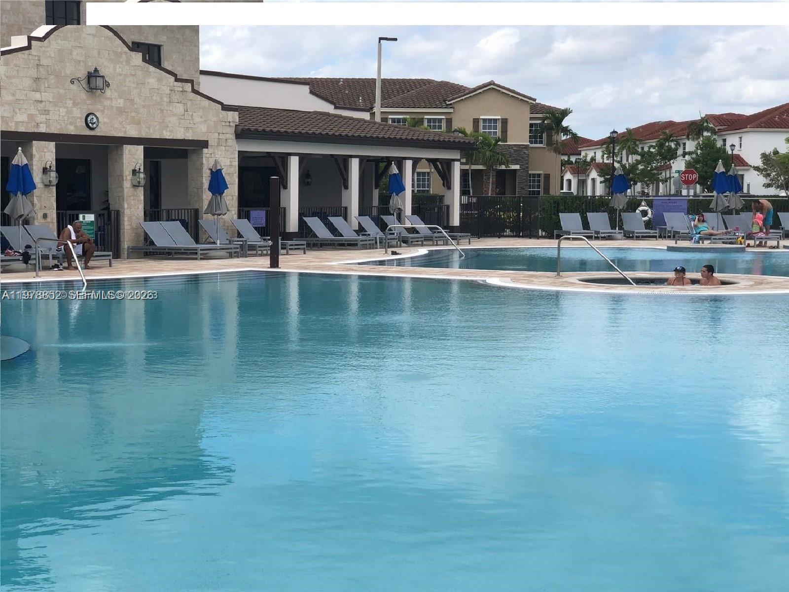17120 Southwest 95th Terrace, Unit STUDIO Miami, FL 33196 - Photo 9 of 10 a view of a building with a water fall and potted plants