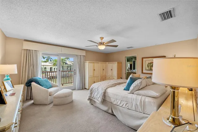 an aerial view of a house with swimming pool and outdoor seating