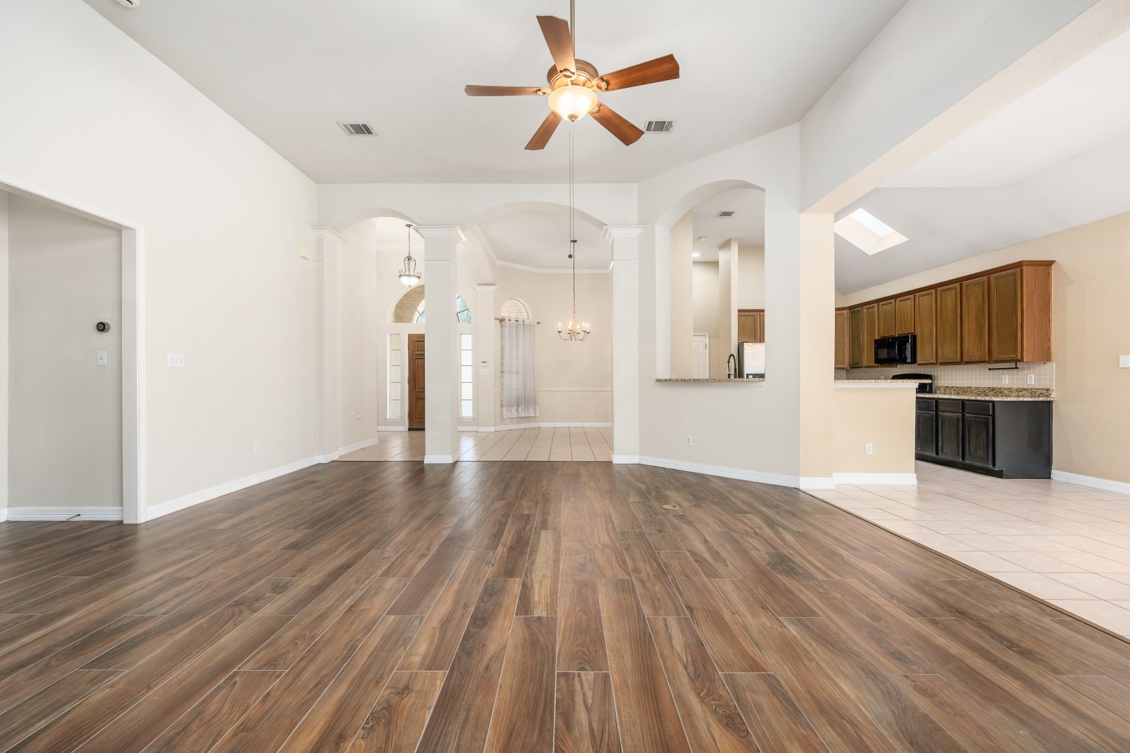 1108 Antelope Ridge Cedar Park, TX 78613 - Photo 22 of 39 Rich wood-look flooring flows throughout an airy, open layout with arched passageways.