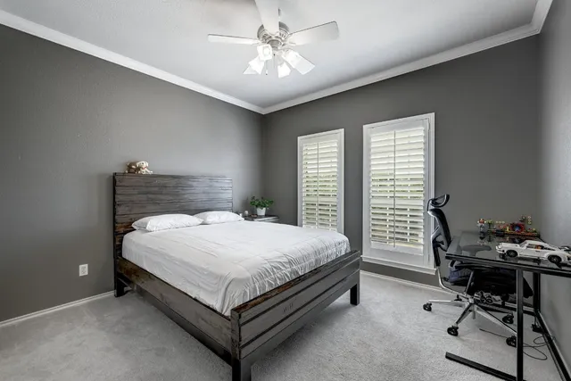 a bed sitting in a bedroom next to a window
