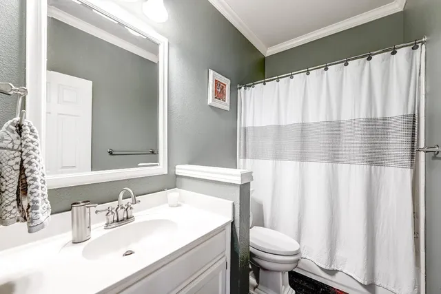 a bathroom with a sink toilet and a mirror