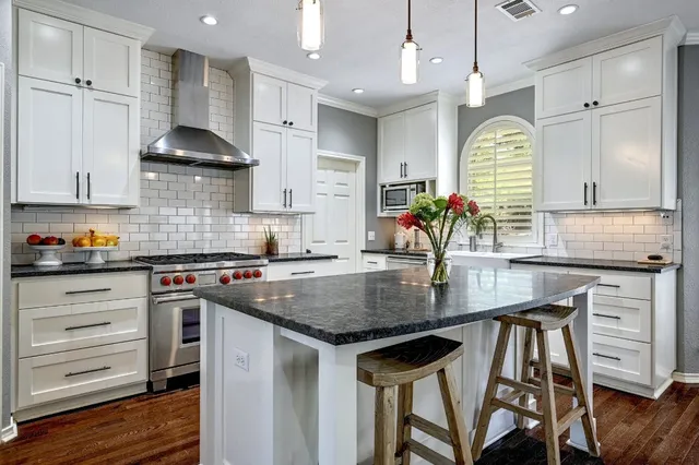 a kitchen with a table chairs stove and cabinets