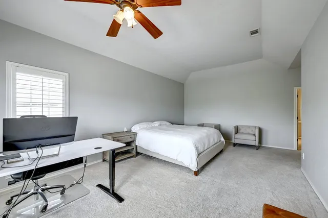 a bedroom with a bed and a desk
