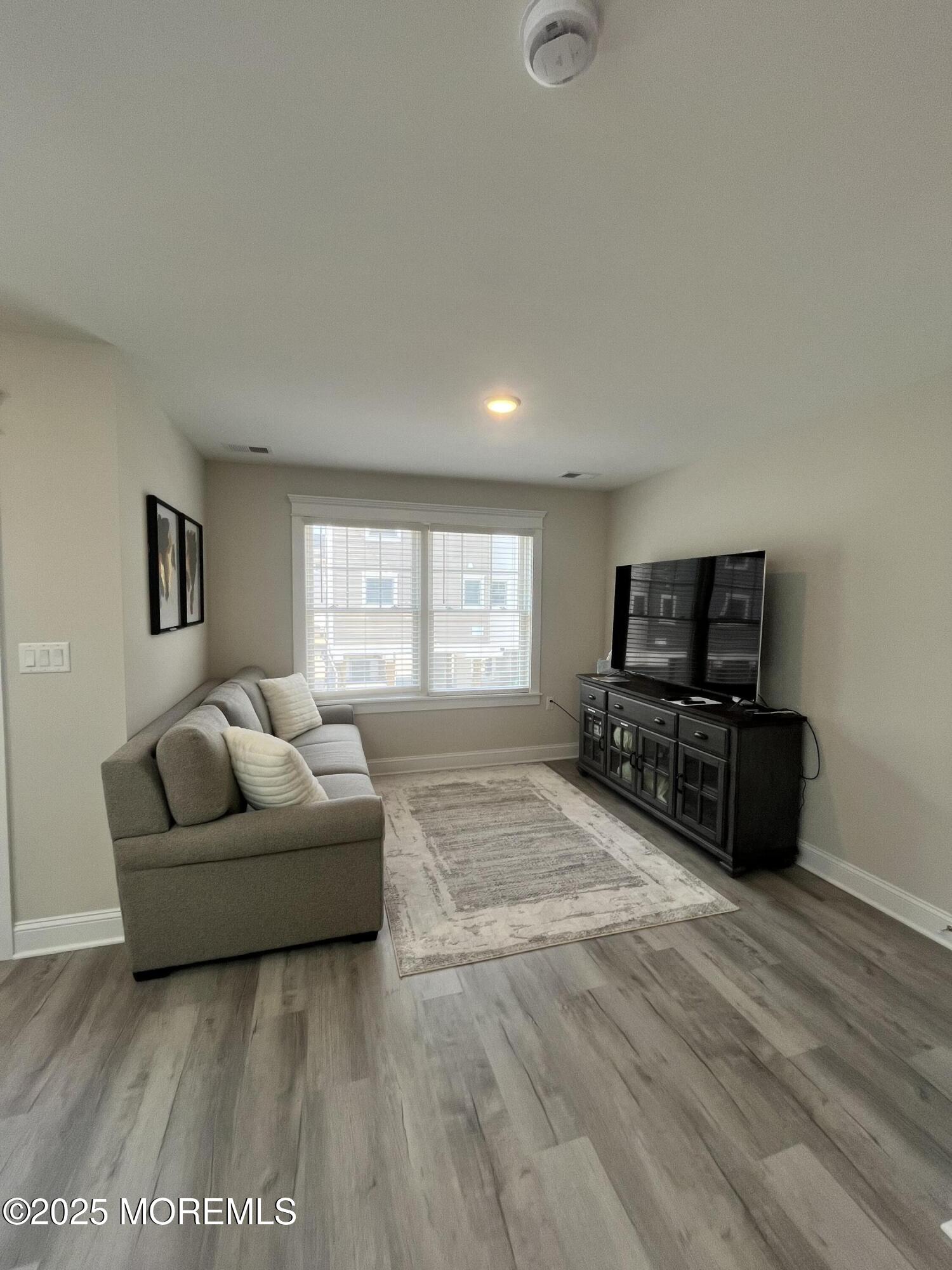 16 Elder Street, Unit 78 Mantoloking, NJ 08738 - Photo 11 of 26 a living room with furniture and a flat screen tv