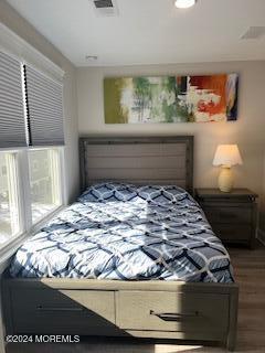 16 Elder Street, Unit 78 Mantoloking, NJ 08738 - Photo 15 of 26 a bed sitting in a bedroom next to a window