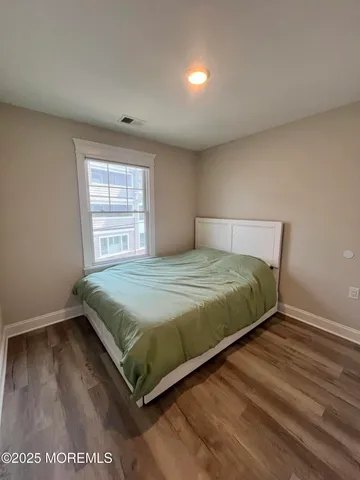 a bed sitting in a bedroom next to a window