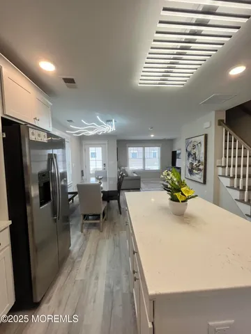 a view of dining room with furniture and a chandelier