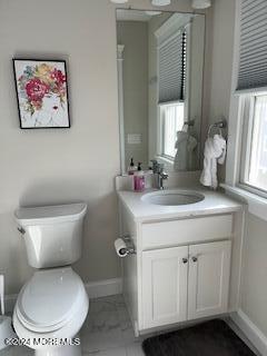 16 Elder Street, Unit 78 Mantoloking, NJ 08738 - Photo 23 of 26 a bathroom with a toilet sink and mirror