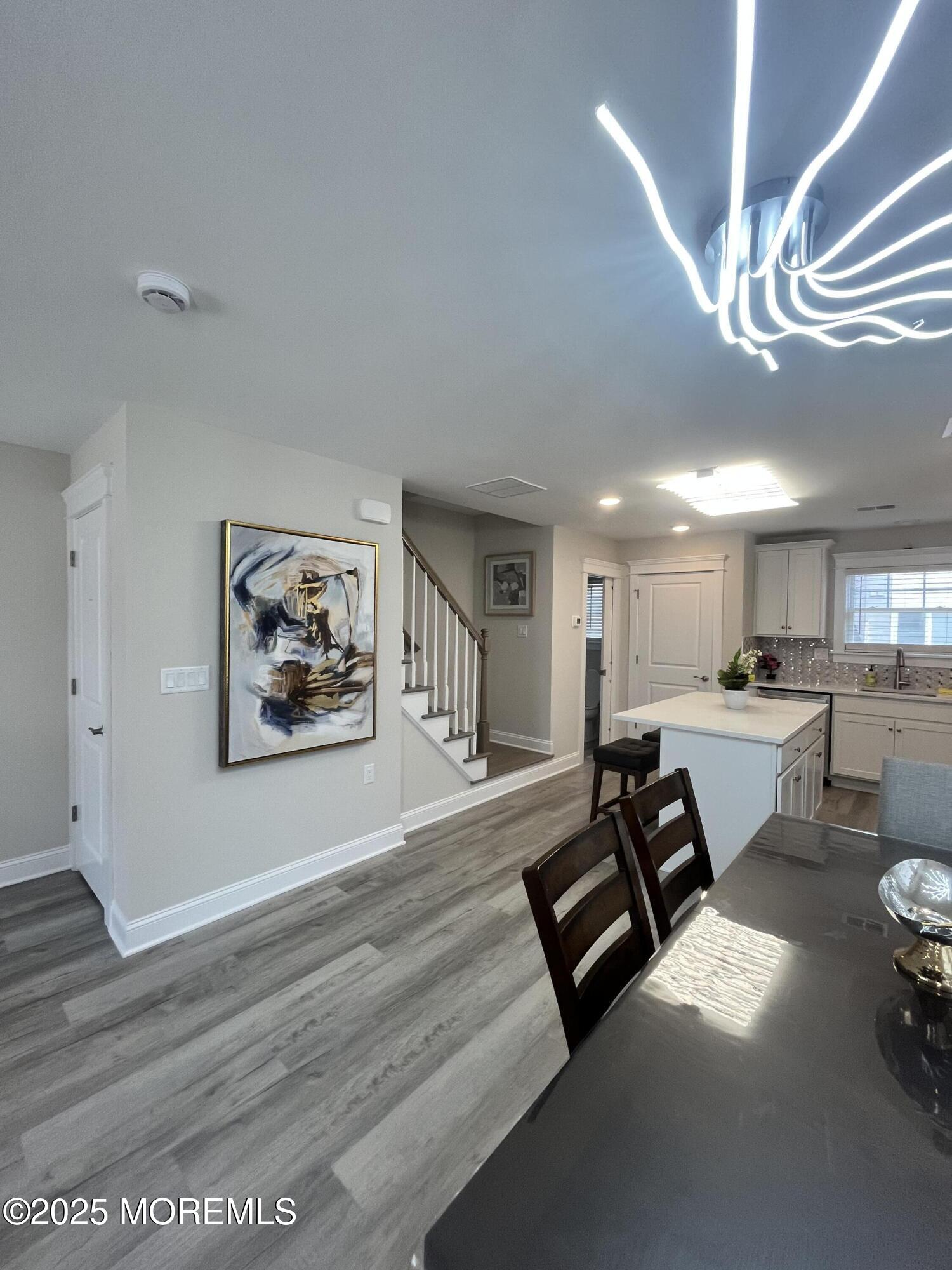 16 Elder Street, Unit 78 Mantoloking, NJ 08738 - Photo 3 of 26 a view of dining room with furniture and a chandelier
