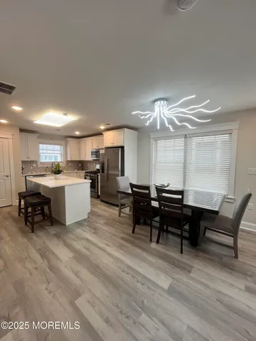 a kitchen with granite countertop a sink a stove and cabinets