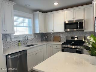 16 Elder Street, Unit 78 Mantoloking, NJ 08738 - Photo 5 of 26 a kitchen with granite countertop a sink a stove and cabinets