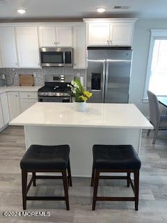 16 Elder Street, Unit 78 Mantoloking, NJ 08738 - Photo 6 of 26 a kitchen with stainless steel appliances a stove a sink refrigerator and cabinets