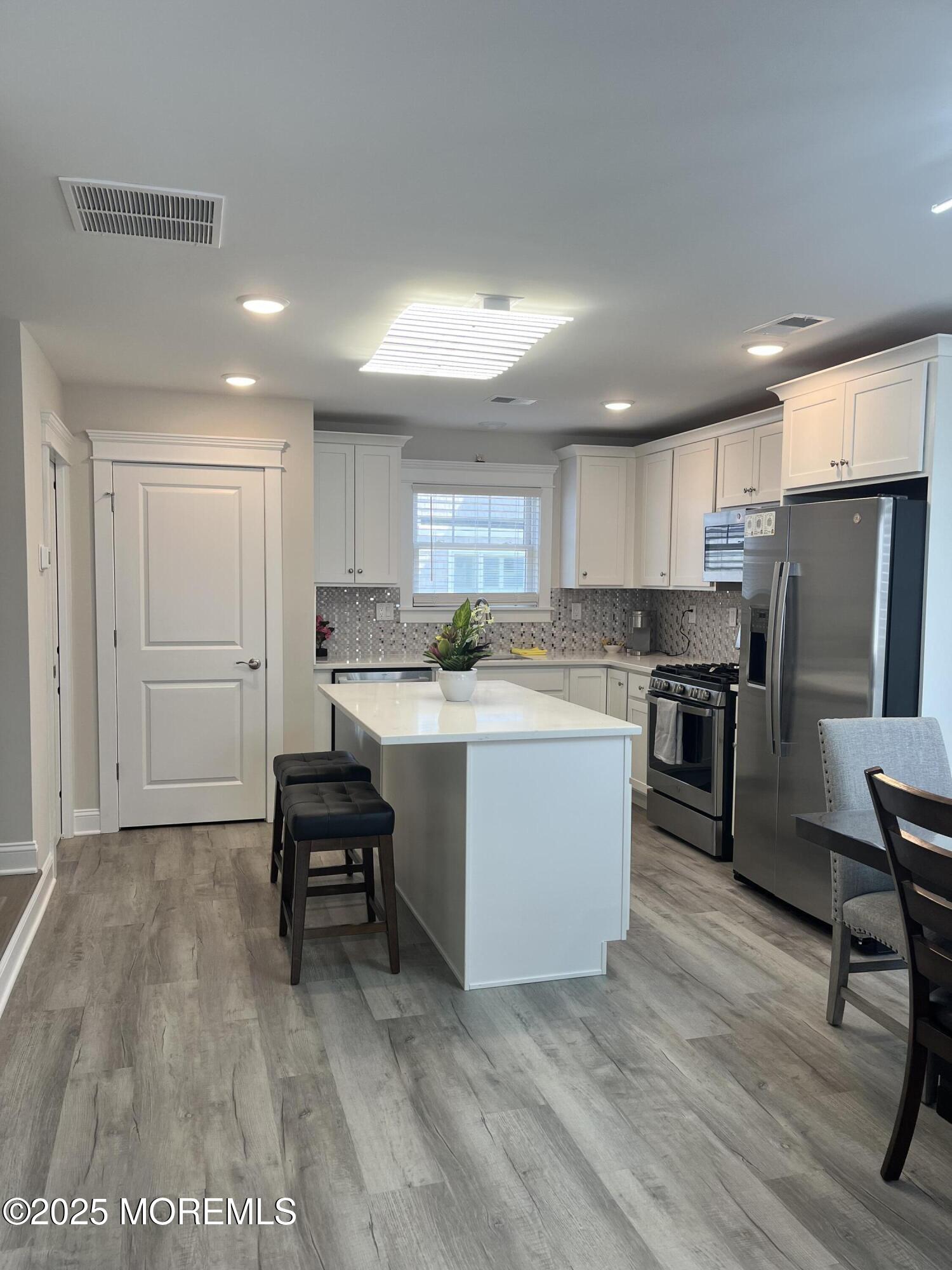 16 Elder Street, Unit 78 Mantoloking, NJ 08738 - Photo 8 of 26 a kitchen with a refrigerator a counter top space and cabinets