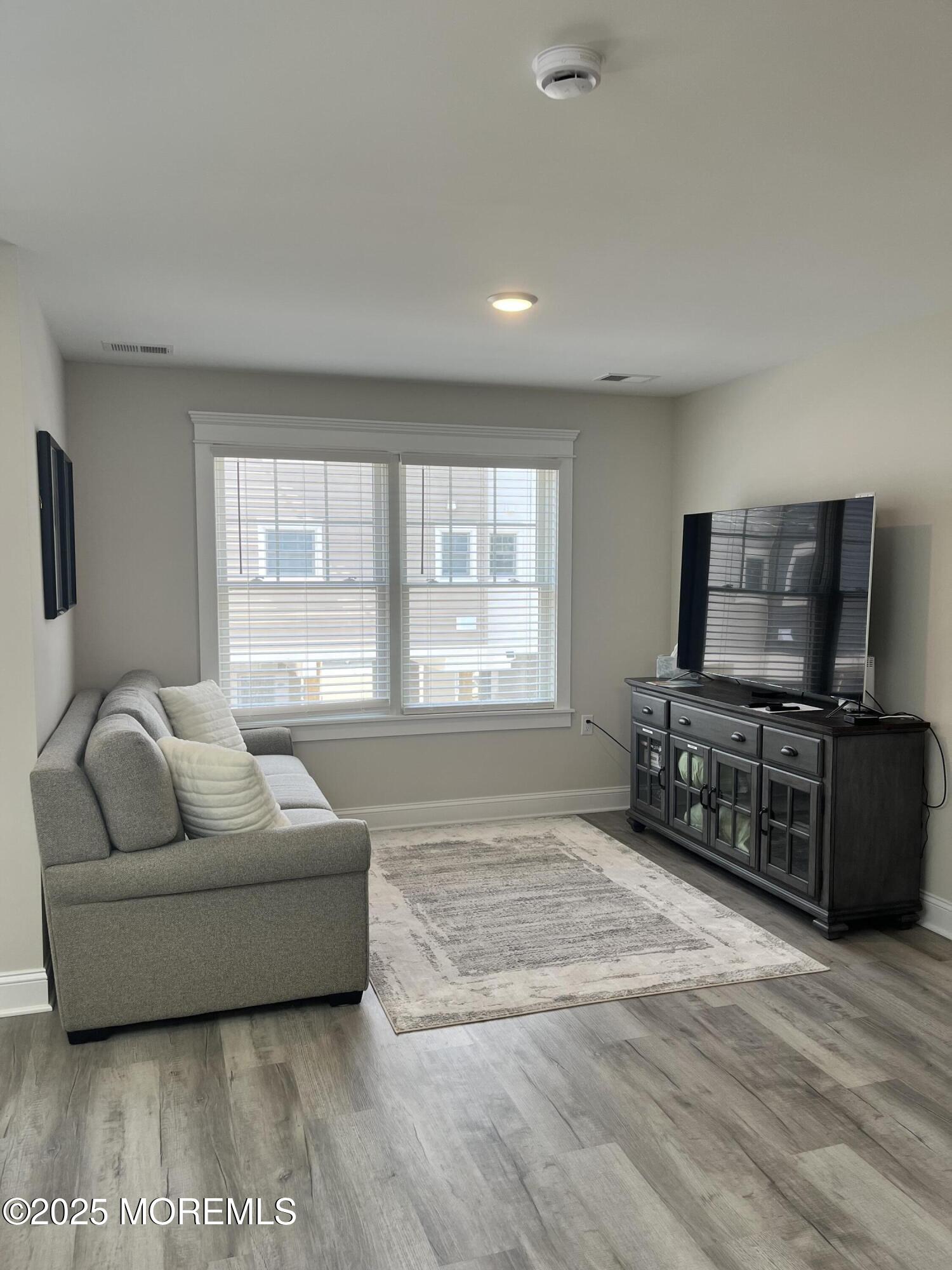16 Elder Street, Unit 78 Mantoloking, NJ 08738 - Photo 10 of 26 a living room with furniture and a flat screen tv