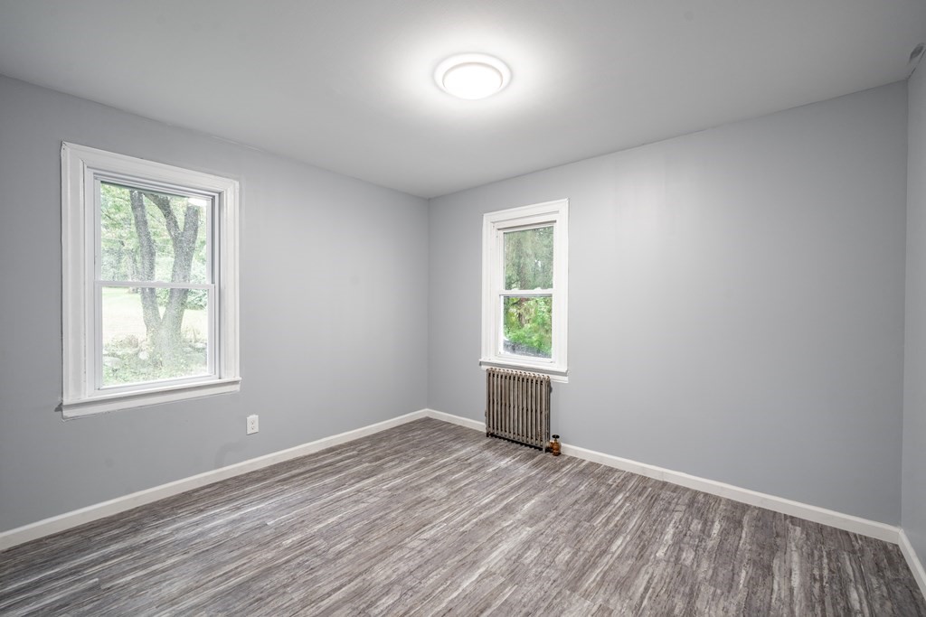 21 Wilbraham Road Monson, MA 01057 - Photo 19 of 26 an empty room with a window and wooden floor