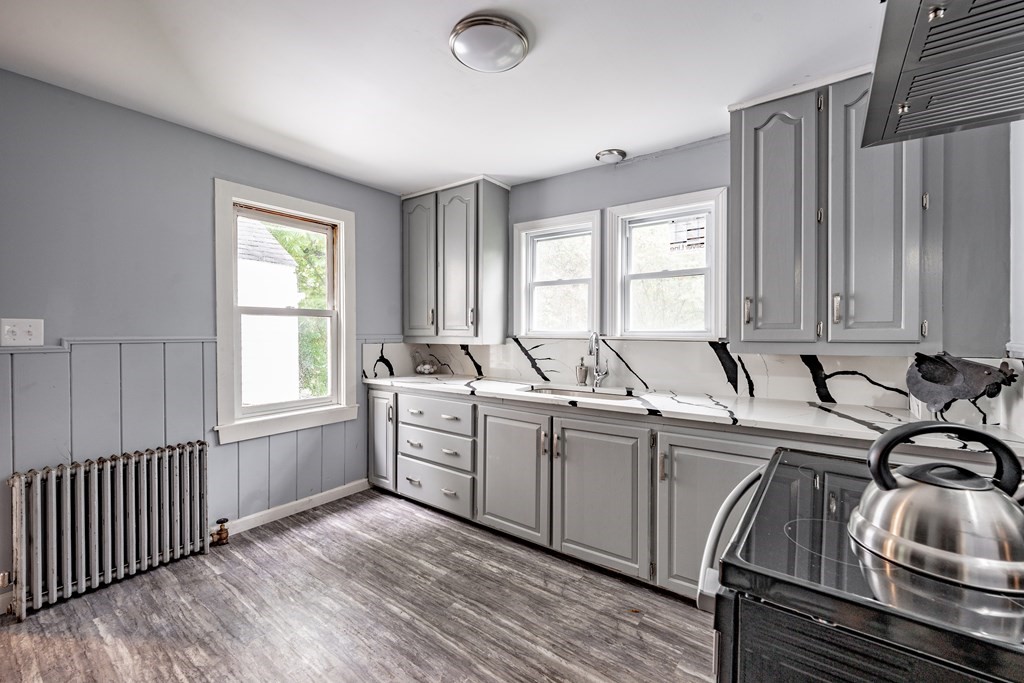 21 Wilbraham Road Monson, MA 01057 - Photo 4 of 26 a kitchen with sink cabinets and wooden floor